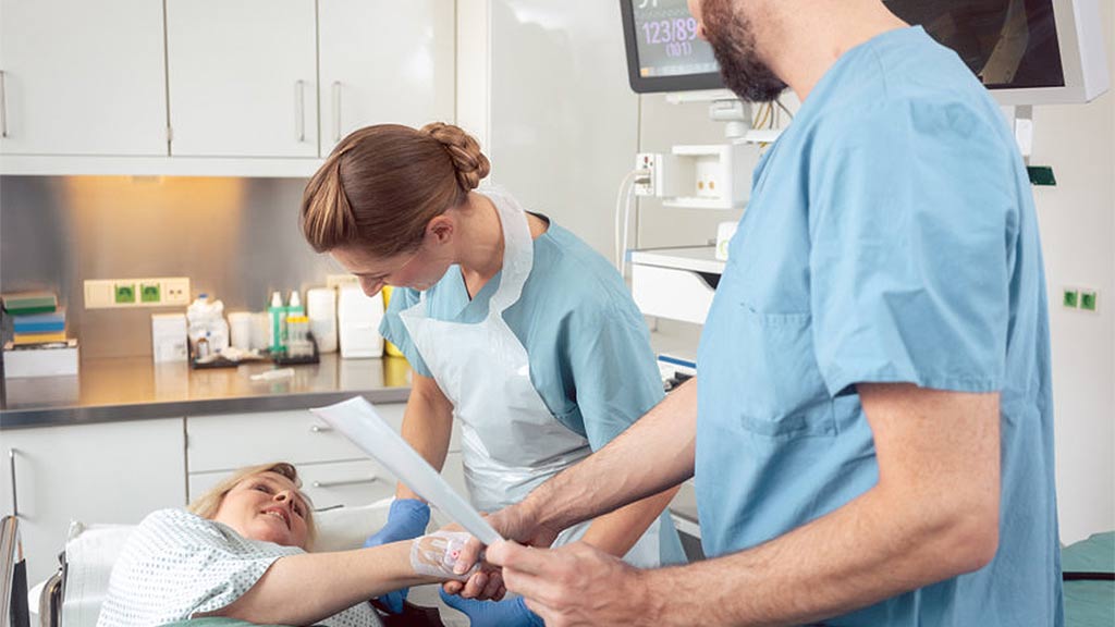 nurses assisting a patient